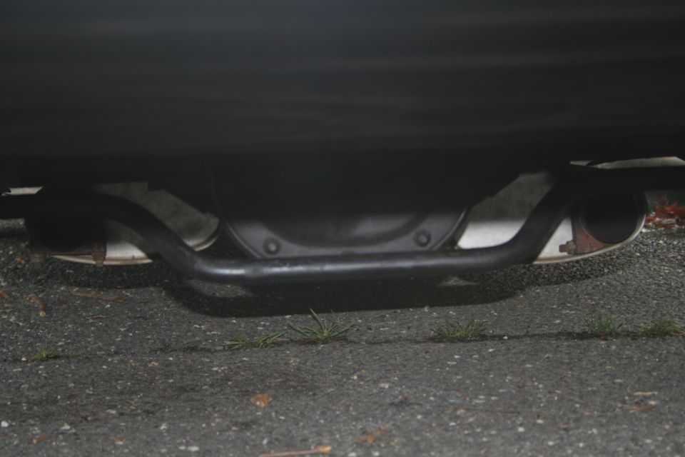 Underside view of a car's rear differential and dual exhaust pipes