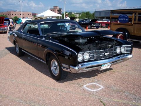 1972 Ford Ranchero - A black 1969 Mercury Cougar XR-7 is displayed with its hood open at an outdoor event.