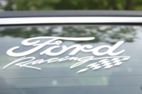 1989 Ford Crown Victoria LTD - Close-up of a Ford Racing sticker on a car window, with a Supermotors.net watermark.