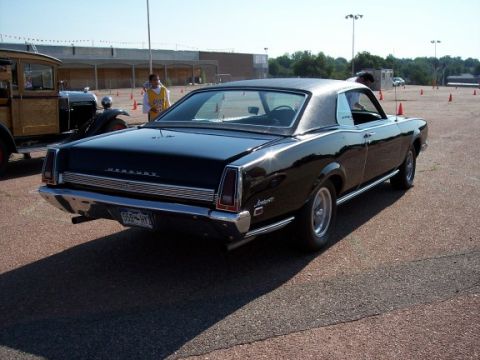 1972 Ford Ranchero - A black Mercury Cougar XR-7 is parked on asphalt with orange cones in the background.