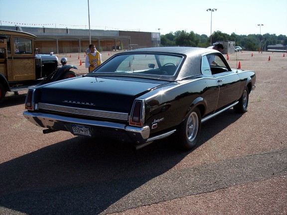 Black 1967 Mercury Cougar XR-7 coupe, rear three-quarter view, shiny paint, vinyl roof