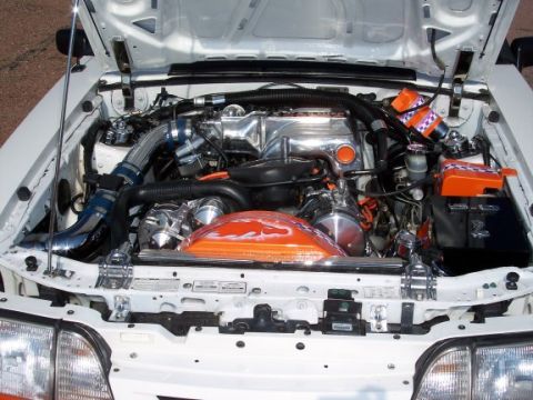 1972 Ford Ranchero - Customized engine bay chrome components and vibrant orange accents, with the hood open.