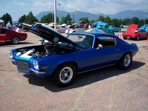 1972 Ford Ranchero - A blue coupe with its hood open, revealing the engine, sits at an outdoor car show.
