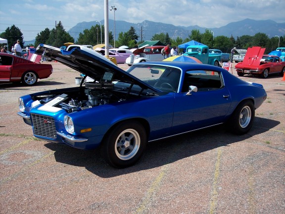 Blue coupe with hood open, showing engine. 1970s styling