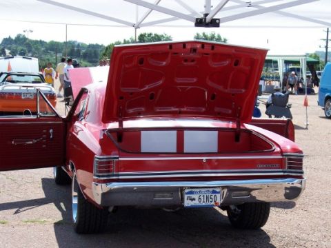 1972 Ford Ranchero - 1967 Chevrolet Chevelle SS coupe shown from the rear with its trunk open at an outdoor car show.