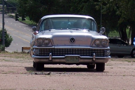 1972 Ford Ranchero - A silver 1958 Buick Special sedan is parked outdoors, with another car visible in the background.