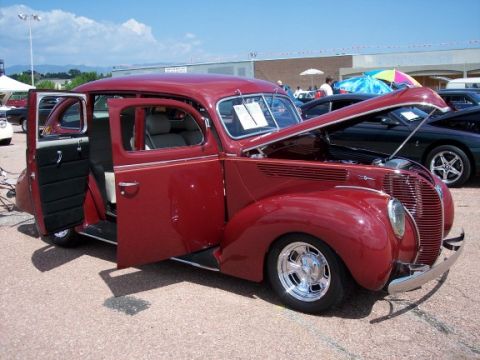 1972 Ford Ranchero - This classic red sedan, likely a 1939 Ford, is displayed with its hood and doors open.