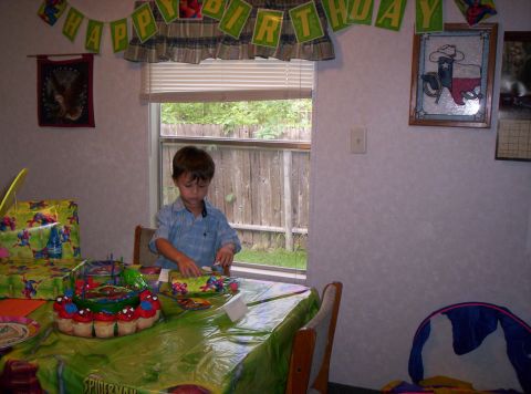 1986 Ford Bronco - A birthday party is set up with a cake and decorations, and a young boy is at the table.