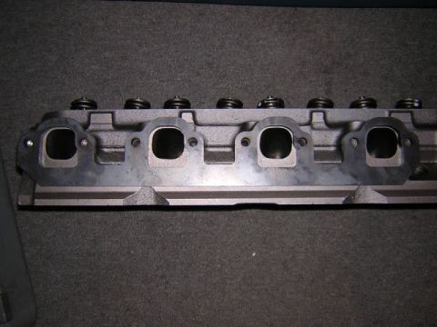 1979 Ford Bronco - Close-up view of an engine cylinder head, showing the exhaust ports and valve springs.