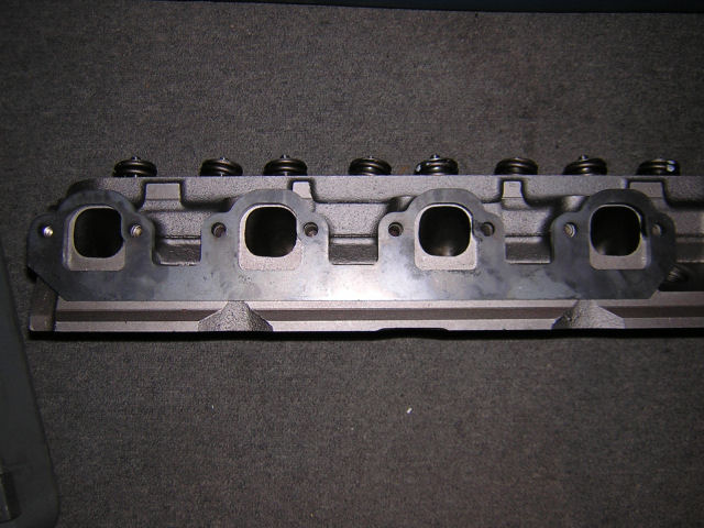 Engine cylinder head with exhaust ports visible