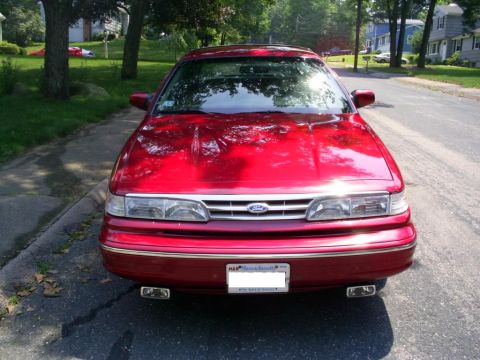 1995 Ford Crown Victoria - Front view of a red 1995 Ford Crown Victoria parked on a residential street.