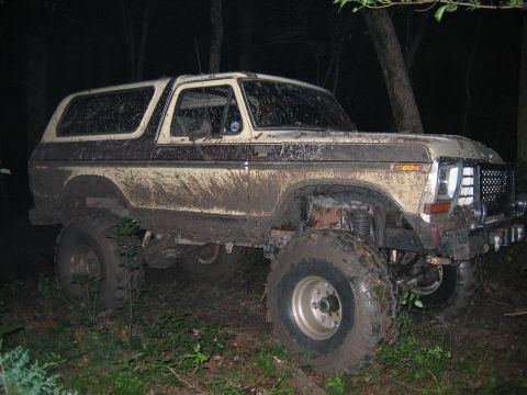 1992 Ford Mustang - This heavily modified 1978 Ford Bronco is shown off-road, covered in mud.