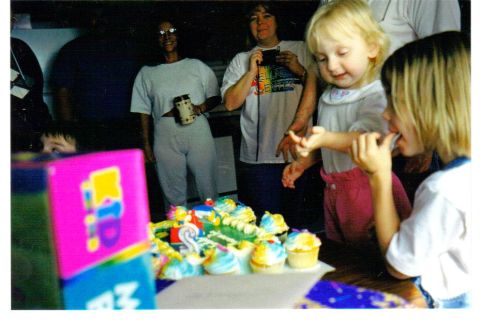 1989 Ford Bronco - A birthday celebration with cupcakes and guests, children and adults.