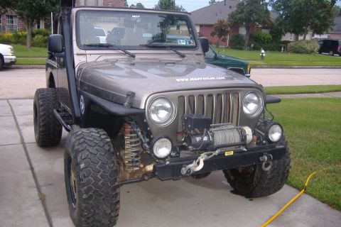 2004 Jeep Wrangler - This 2004 Jeep Wrangler features a front winch and a snorkel, indicating off-road modifications.