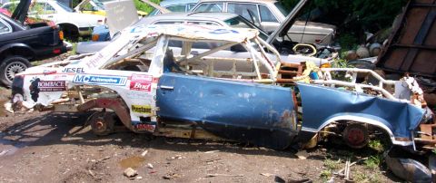 1978 Ford Bronco - This heavily damaged race car, stripped down and reinforced with a rollcage, sits in a junkyard.