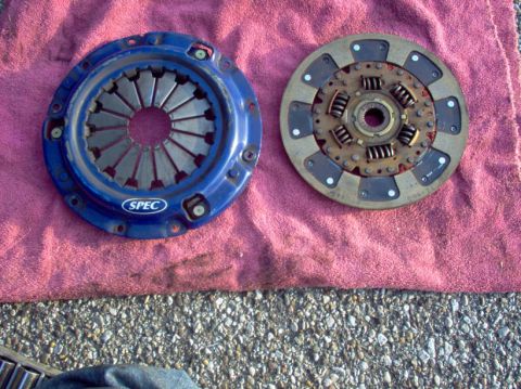 1994 Ford Probe - A blue SPEC clutch assembly and a pressure plate are displayed side-by-side on a red cloth.