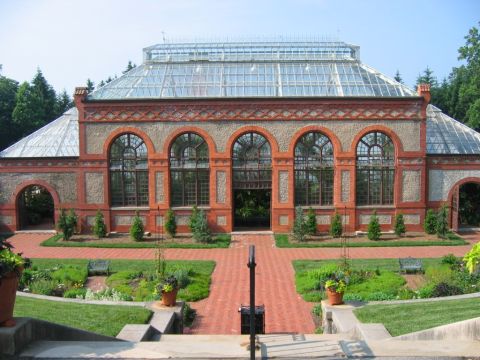 1985 Ford Crown Victoria LTD - Exterior view of a large conservatory building with ornate brickwork and extensive glass panels.