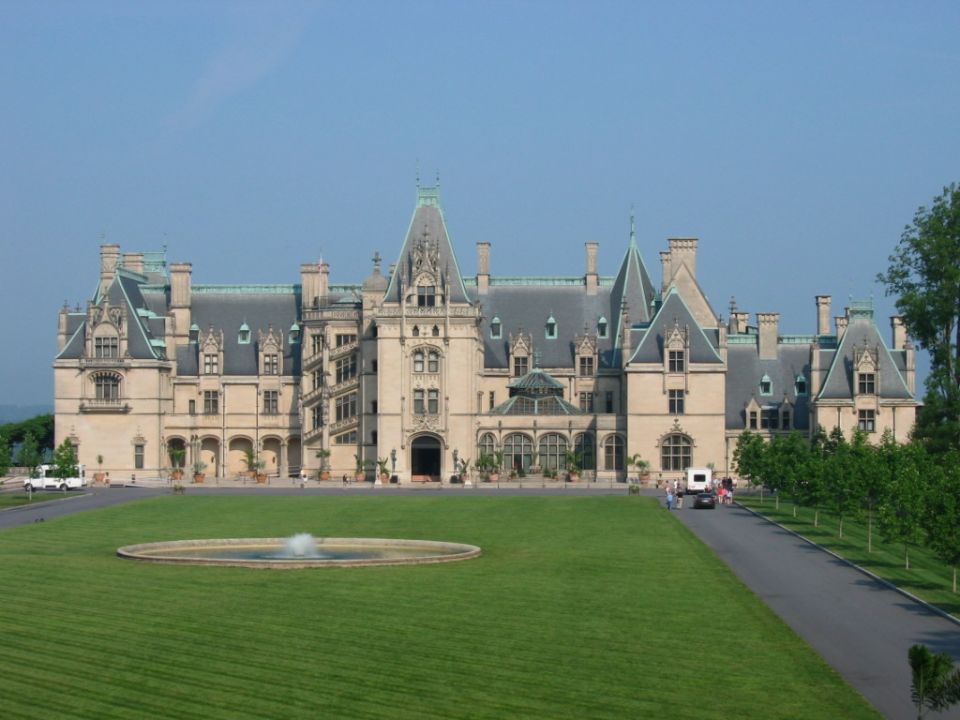 Biltmore Estate with a fountain in the foreground and a road leading to the entrance