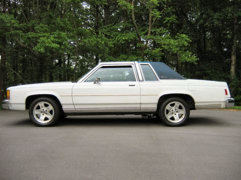 1985 Ford LTD Crown Victoria - Side profile of a classic Ford Crown Victoria coupe with a two-tone paint scheme and chrome trim.