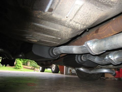 1985 Ford LTD Crown Victoria - Low-angle underbody shot of a vehicle showing a dual exhaust system with fresh aluminized pipes, a large black muffler labeled 'INLET', and…