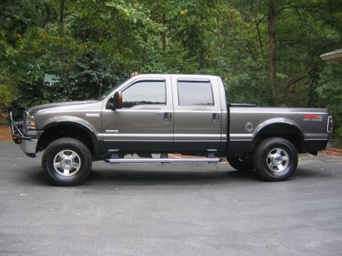 2005 Ford F-250 - This 2005 Ford F-250 Super Duty crew cab pickup truck is shown from the side, a brush guard and "4x4 OFF ROAD" badging.