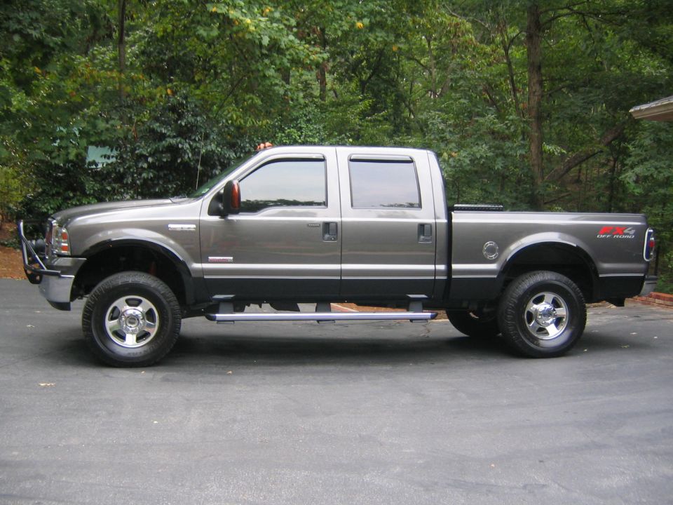 Gray 2005 Ford F-250 Super Duty crew cab pickup truck with brush guard and "4x4 OFF ROAD" badging