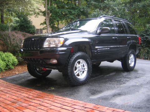 2005 Ford F-250 - This black Jeep Grand Cherokee features a lifted suspension and off-road tires, suggesting it's ready for adventure.
