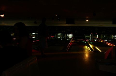 2001 Mercury Grand Marquis - A dimly lit bowling alley scene with glowing lanes and pins visible in the distance.