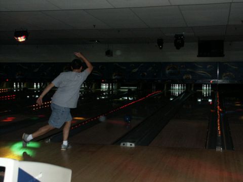 2001 Mercury Grand Marquis - A person bowls in a dimly lit bowling alley.