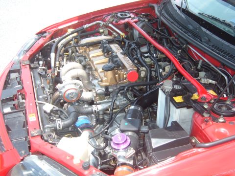 1989 Ford Probe - Customized engine bay a turbocharger and aftermarket strut bar.