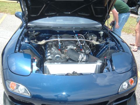 1989 Ford Probe - Engine bay of a blue car, modified with a new engine and cooling system.