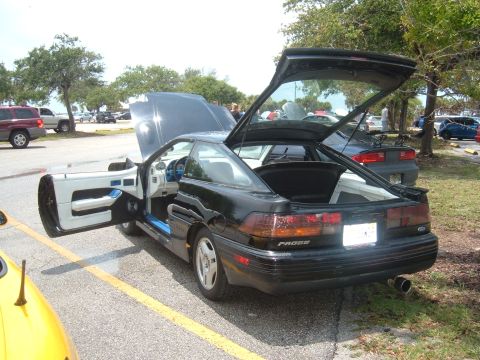 1989 Ford Probe - A black 1989 Ford Probe is shown with its hood and doors open, revealing the interior and trunk space.