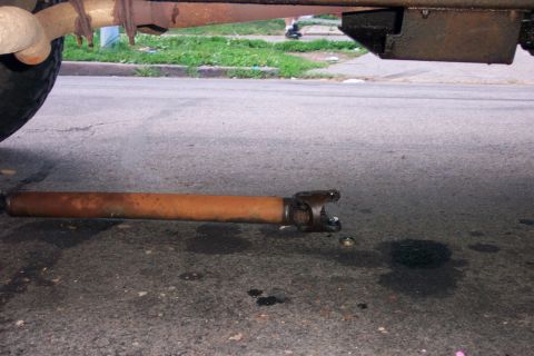 1979 Ford F-250 - The driveshaft has come loose from the vehicle, lying on the asphalt.