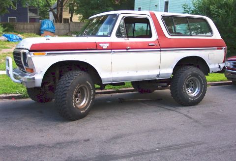 1979 Ford F-250 - This lifted Ford Bronco features a two-tone paint scheme and a front brush guard, suggesting a model year around 1978.