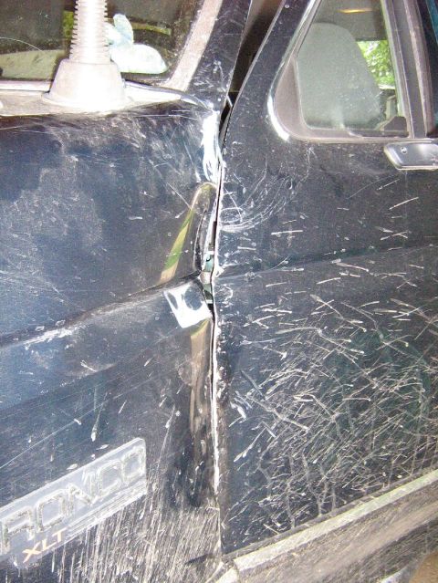 1995 Ford Bronco - This 1995 Ford Bronco XLT shows extensive body damage to the driver's side door and frame.