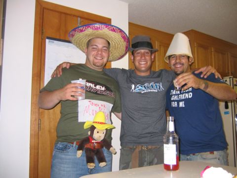 1986 Ford Mustang - Three men pose for a photo at a party, one wearing a sombrero and another a lampshade as a hat.