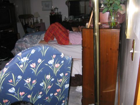 1986 Ford Mustang - A person is sleeping in a bed in a bedroom. The room has furniture and a television.