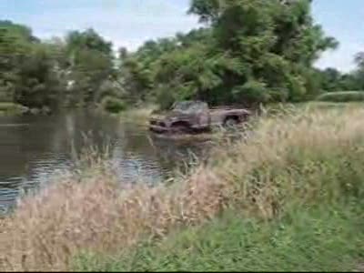 1973 Ford F-250 - A shot of the truck cutting across the mud hole