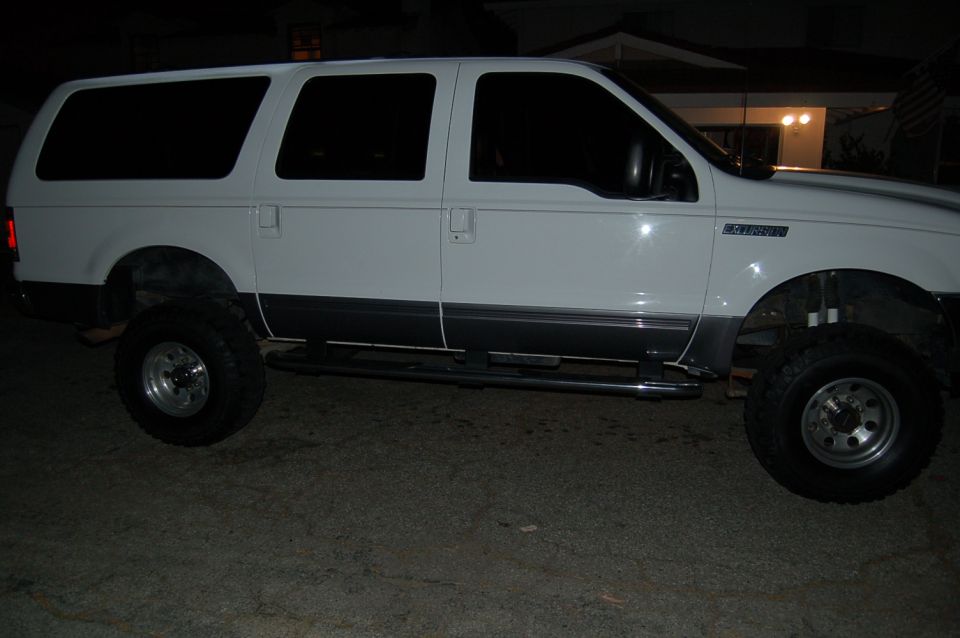 White 2001 Ford Excursion side view with lifted suspension