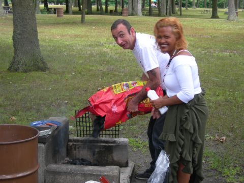 1992 Ford Taurus - Two people are preparing to start a barbecue in a park setting.