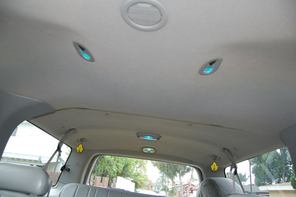 Interior ceiling of a vehicle with multiple dome lights and air vents