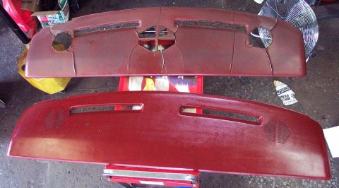 1985 Ford LTD Crown Victoria - Two burgundy dash pads laid on a shop floor for comparison: the upper one is badly cracked with large holes torn through the vinyl at the d…