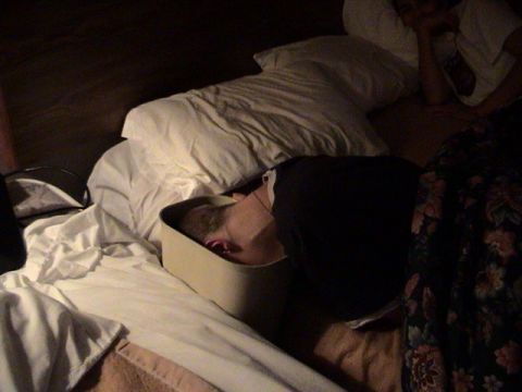 1989 Ford Bronco - A person is sleeping in a bed, partially obscured by bedding and a pillow.