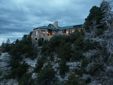 2001 Mercury Grand Marquis - A large stone building sits atop a cliff, illuminated by interior lights against a darkening sky.