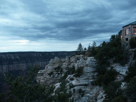 2001 Mercury Grand Marquis - View of a canyon with a stone building on the cliff edge, under a cloudy sky. Supermotors.net logo is present.