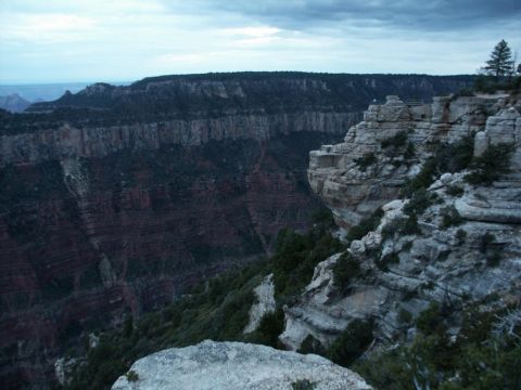 2001 Mercury Grand Marquis - A wide shot of the Grand Canyon shows layered rock formations under a cloudy sky.