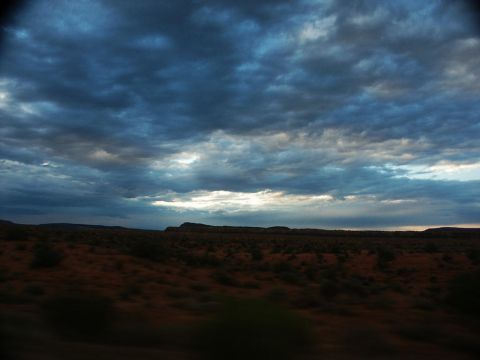 2001 Mercury Grand Marquis - Dramatic clouds gather over a desert landscape during a trip.