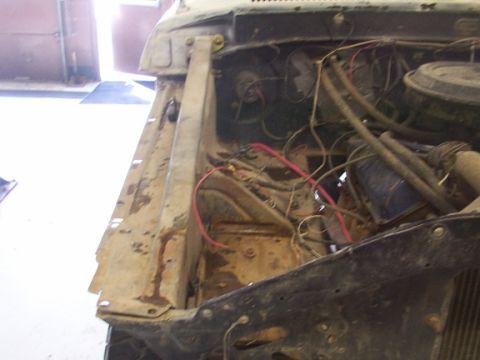 1978 Ford Bronco - The engine bay of a vehicle shows exposed wiring and mechanical parts, with visible signs of wear and tear.