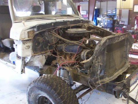 1978 Ford Bronco - The front end of a 1978 Ford Bronco is shown disassembled, revealing the engine and suspension.