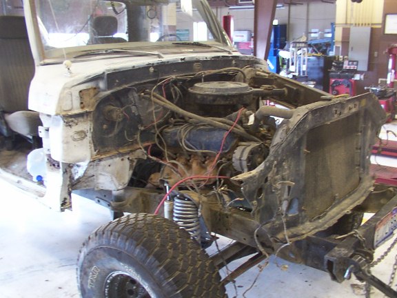 1978 Ford Bronco front end disassembled, showing engine and suspension components